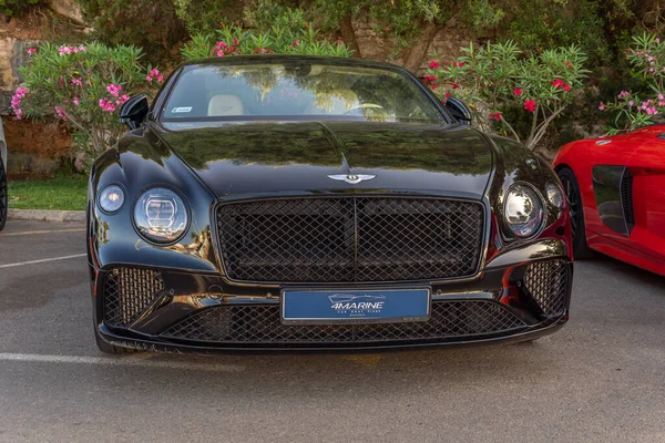 Cala d'Or, Spain; june 25 2022: Bentley luxury black car, parked in the marina of the Majorcan town of Cala d'Or, Spain
