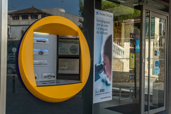 Arta, Spain; august 13 2022: Close-up of an ATM of the Caixabank banking company, in the Mallorcan town of Arta