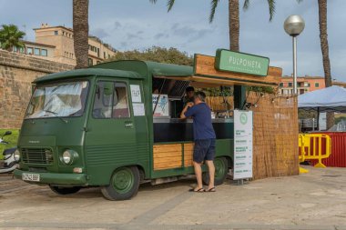 Palma de Mallorca, Spain; september 03 2022: Van Van Palma street food festival at sunset. Island of Mallorca, Spain. Van selling street food