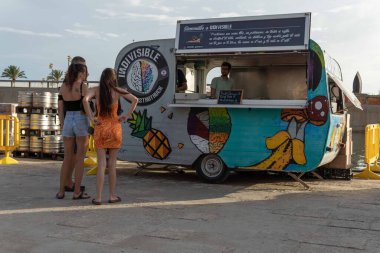 Palma de Mallorca, Spain; september 03 2022: Van Van Palma street food festival at sunset. Island of Mallorca, Spain. Van selling street food