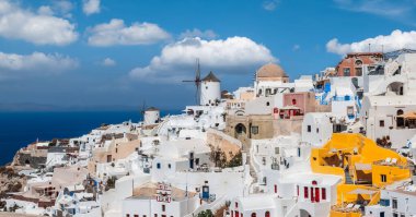 Panoramic skyline view of Greek village Oia on Santorini island in Greece on a beautiful vacation day.