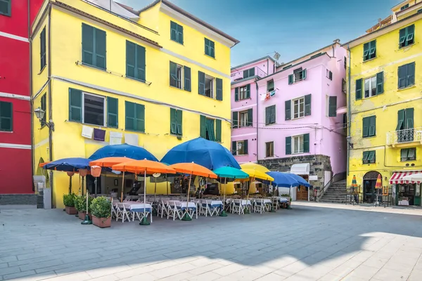 Colorful terrace umbrellas on town square, Vernazza, Cinque Terre, Italy.