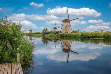The historic windmills of Kinderdijk reflecting in the canal, South Holland, Netherlands. clipart