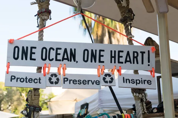 Wooden sign in favour of recycling and environmental protection. Inspiring message about the fight against pollution and the protection of the oceans.