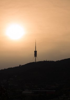 Telecommunications tower Collserola Tower on the Tibidabo hill in the Serra de Collserola in Barcelona (Catalonia, Spain). Telecommunications tower at sunset.