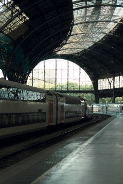 Lonely platform with a train parked at Frana train station (France Station) in Barcelona (Catalonia, Spain). 