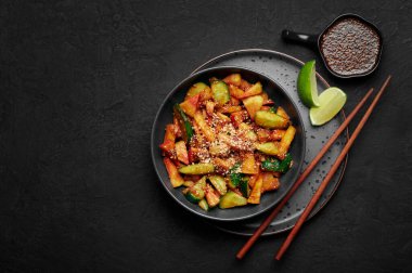 Penang Rojak in black bowl on dark slate table top. Malaysian or indonesian cuisine fruits and vegetables salad dish. Asian Food. Top view. Copy space