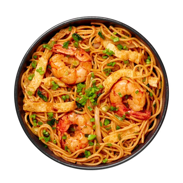 Mie Goreng in black bowl isolated on white. Indonesian cuisine prawn noodles and vegetables stir fired dish. Asian food.