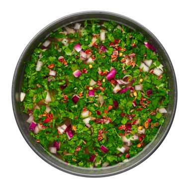 Pachi Pulusu in black bowl isolated on white background. Raw Tamarind Rasam is indian cuisine soup dish. Asian food and meal. Top view