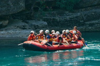 Antalya, Turkey - 02.05.2022. Rafting at the Kepruchay River in Turkey. A group of people in the red boat 