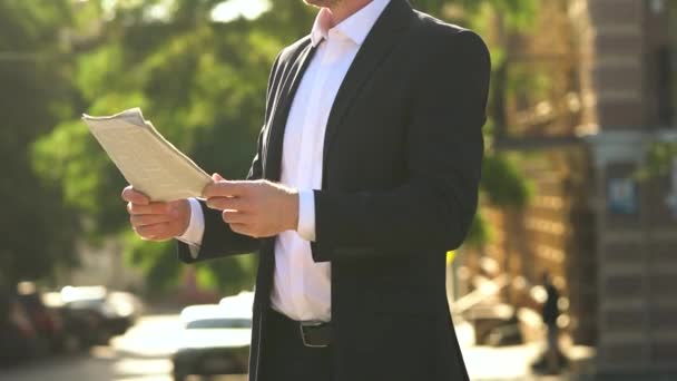Businessman Black Suit Reads Newspaper Magazine Sunset City Close Hands — Stockvideo