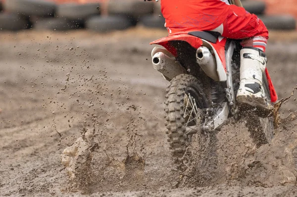 Close-up of dirty wheel of motocross bike in mud