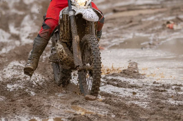 Close-up of dirty wheel of motocross bike in mud