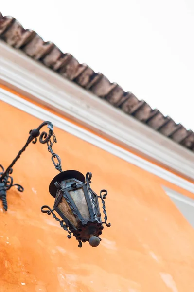 Lamppost, Antigua Guatemala sokaklarında duvarda asılı duruyor.