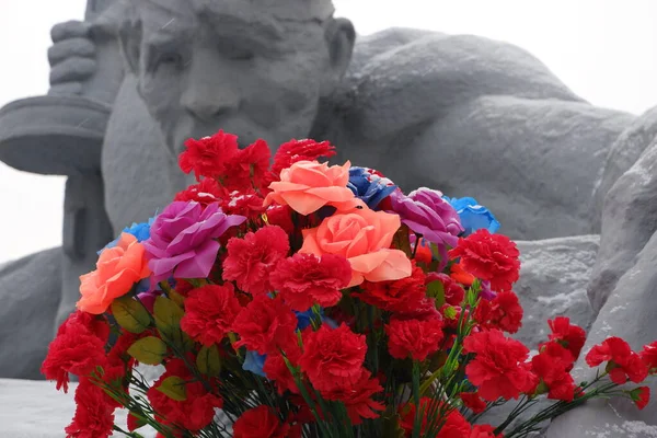 Red flowers at the monument to the fallen Soviet soldiers of the Brest Fortress. May 9. — Stock Photo, Image