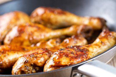 Fried Chicken Drumsticks with Herbs in a Pan clipart