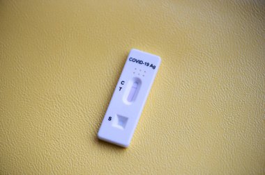 Rapid antigen detection test (RADT) with COVID-19 Ag inscription and one red stripe showing a NEGATIVE result