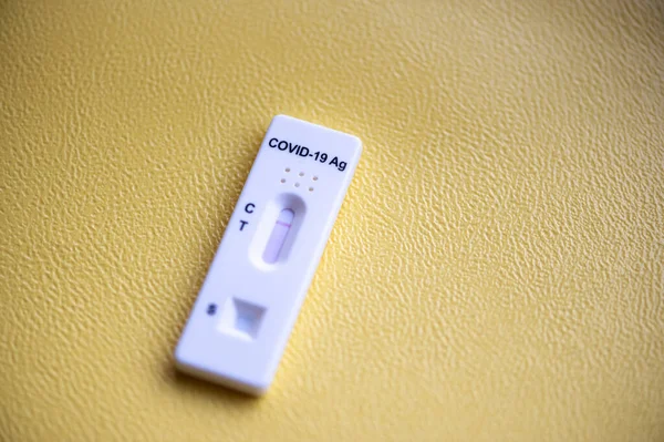 Rapid antigen detection test (RADT) with COVID-19 Ag inscription and one red stripe showing a NEGATIVE