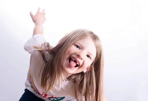little funny girl without front teeth shows tongue isolated on white background