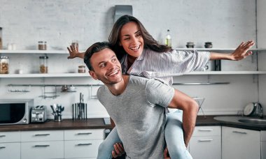 Genç bir çiftin mutfakta komik bir sabahı. Gülümseyen sakallı adam güzel kız arkadaşıyla vakit geçiriyor..