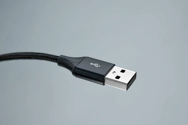 Close-up USB cable connector on gray background