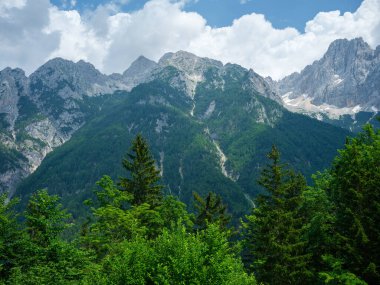 Slovenya 'daki Triglav parkında, mavi bulutlu gökyüzünün altında ve zirvelerinde. Güneşli yaz günü