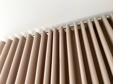 Kahverengi perdeler odanın içinde asılı..