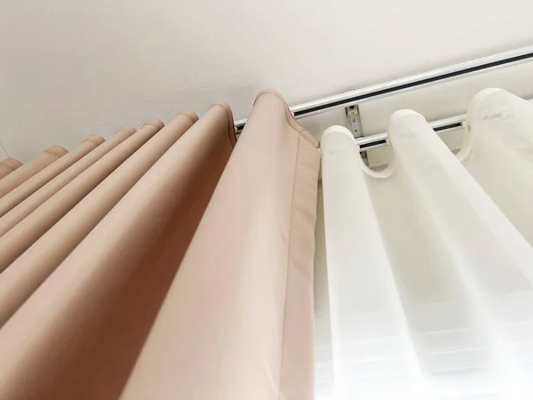Brown curtains and white sheer curtains decorate elegant homes.