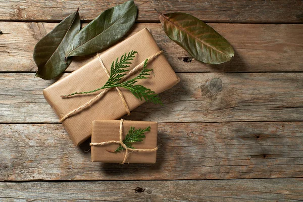 Christmas Packages Wrapped Kraft Paper Tied Jute Rustic Wood Background — Stock Photo, Image