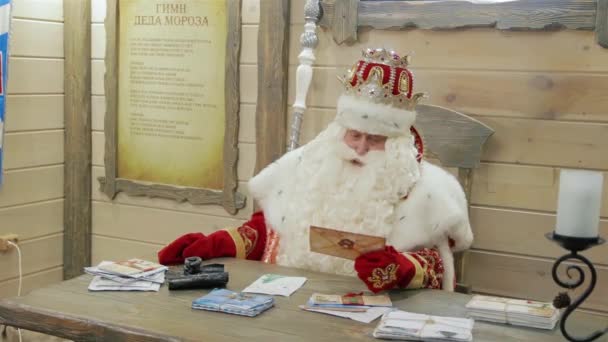 俄罗斯圣诞老人坐在他家的桌子旁。伟大的钢铁之城. 免版税图库视频片段