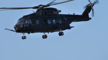 Gösteride siyah helikopter uçuyor.