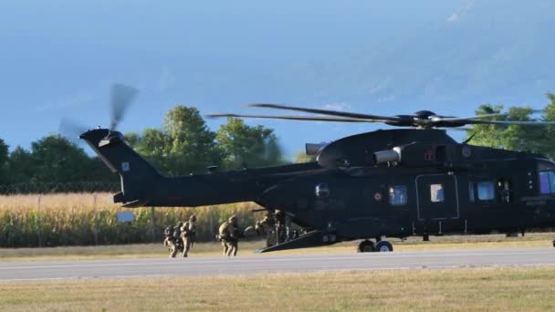 Group of soldiers carry stretchers to helicopter — Stock Video