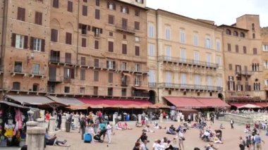 Siena, Toskana 'daki Piazza del Campo, güneşli bir yaz gününde turistlerin istilasına uğradı..