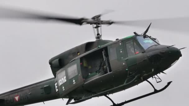 Iconic historic Vietnam War era mimetic green helicopter in flight close up — Stock Video