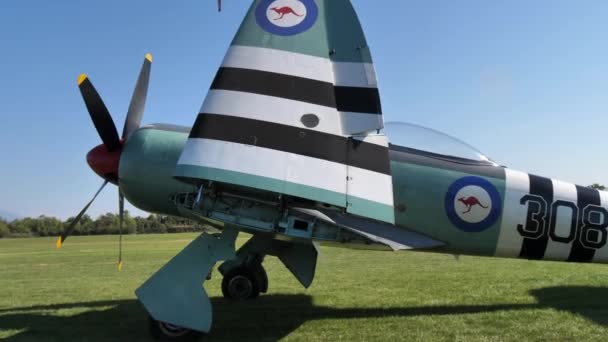Historic propeller combat airplane parked with folded wings — Vídeo de Stock