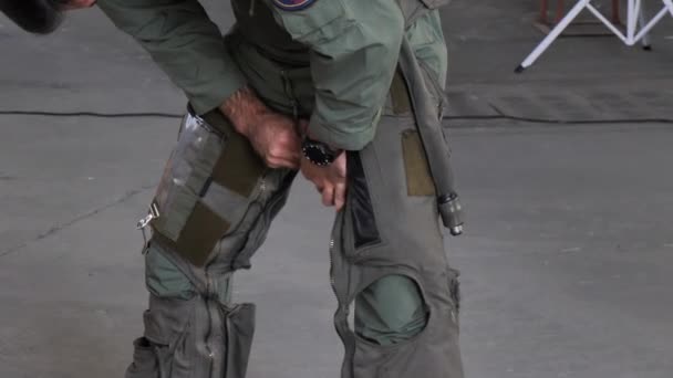 Military fighter aircraft pilot wears anti-g suit pants before flying — Stock Video