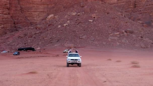 Русті 4х4 позашляховик їдуть пустельною дорогою з туристами на борту — стокове відео