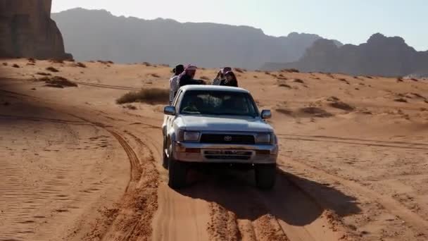 4wd offroad suv їздити по пустельній дорозі з туристами на передньому плані — стокове відео