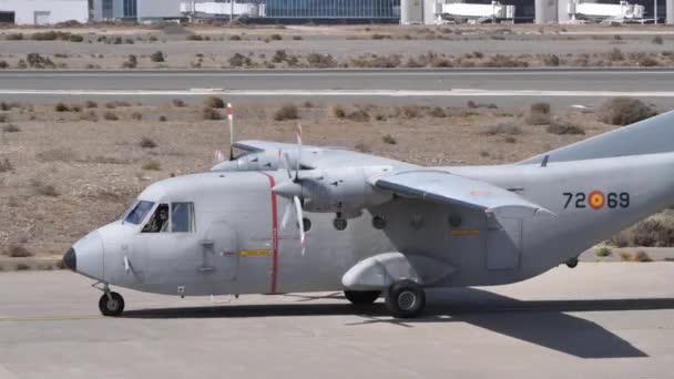 Серый военный турбовинтовой грузовой самолет на взлетно-посадочной полосе авиабазы — стоковое видео