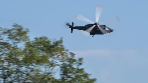 Helicóptero verde militar voando atrás das árvores para se esconder dos inimigos — Vídeo de Stock