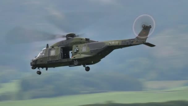 Des hélicoptères militaires de l'OTAN volent à basse altitude dans une vallée pour des manœuvres de guerre — Video