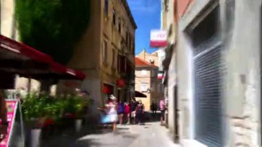 Pula Croatia AUGUST, 15, 2020 Hyperlapse in 4K walking on central historical road and ending at town hall square close to Temple of Augustus. Motion blur effect. Not recognizable people.