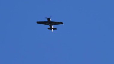Thiene Italy OCTOBER, 17, 2021 Small propeller airplane in flight on intense emerald blue sky without cloud. Sukhoi Su-31 Russian single engine and seat extreme unlimited aerobatic aircraft