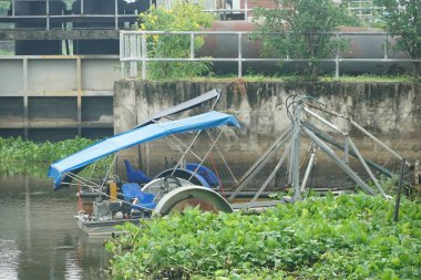 Nehirdeki çim biçme teknesi