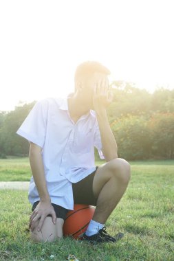 young woman with a cup of coffee and a camera on the grass