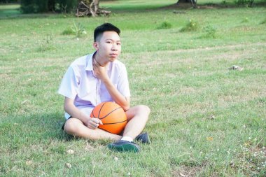 portrait of a young asian man playing basketball