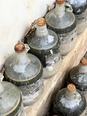old rusty metal jug on a background of a wall