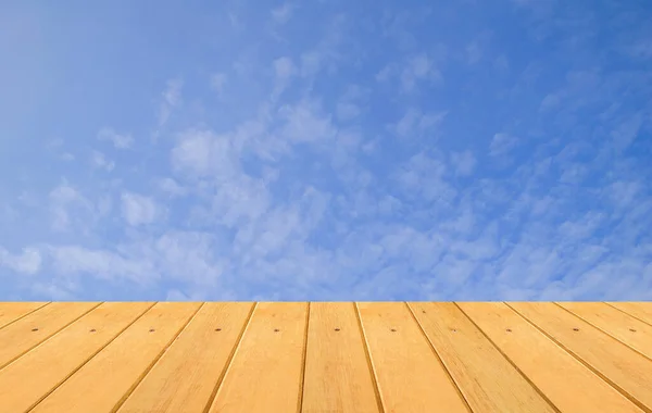 empty wooden table with blue sky background