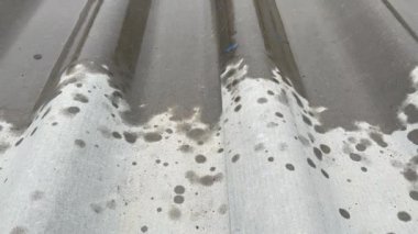 Metal çatılı yağmur fırtınası, çatıdan aşağı akan yağmur suyu.