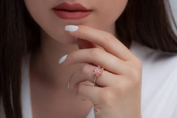 colorful lotus silver paint in well-groomed hands with white nail polish